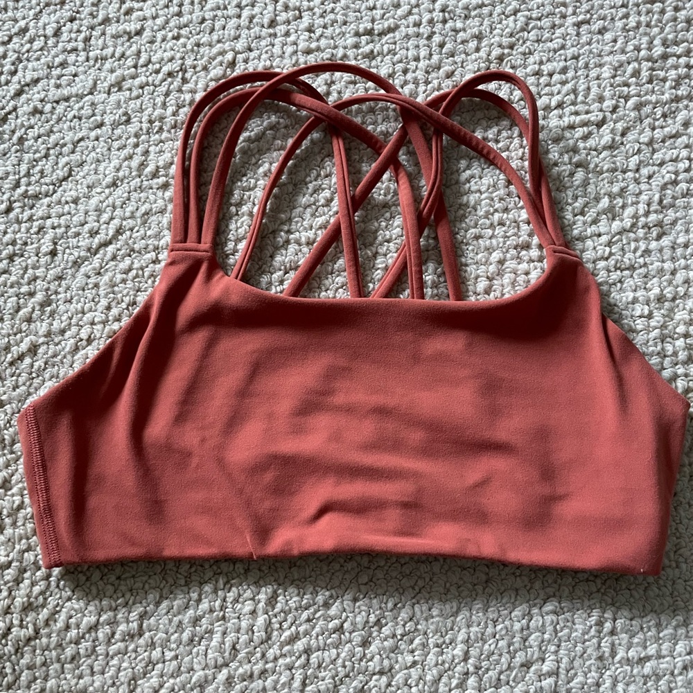 Coral sports bra. Athleta. Still in perfect condition. Size small.